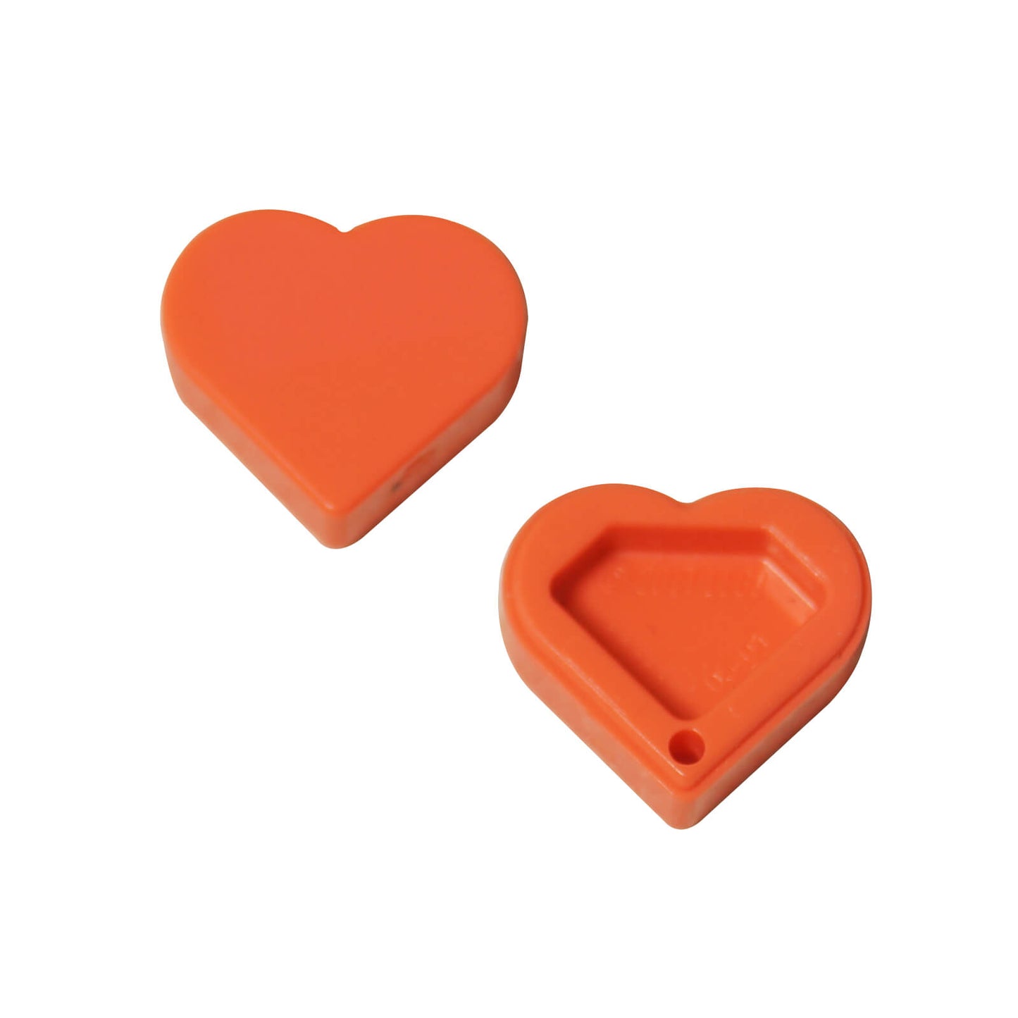 Two coral LEGO Tile, Round 1x1 Heart pieces (39739) shown: one smooth face up, one hollow side up.