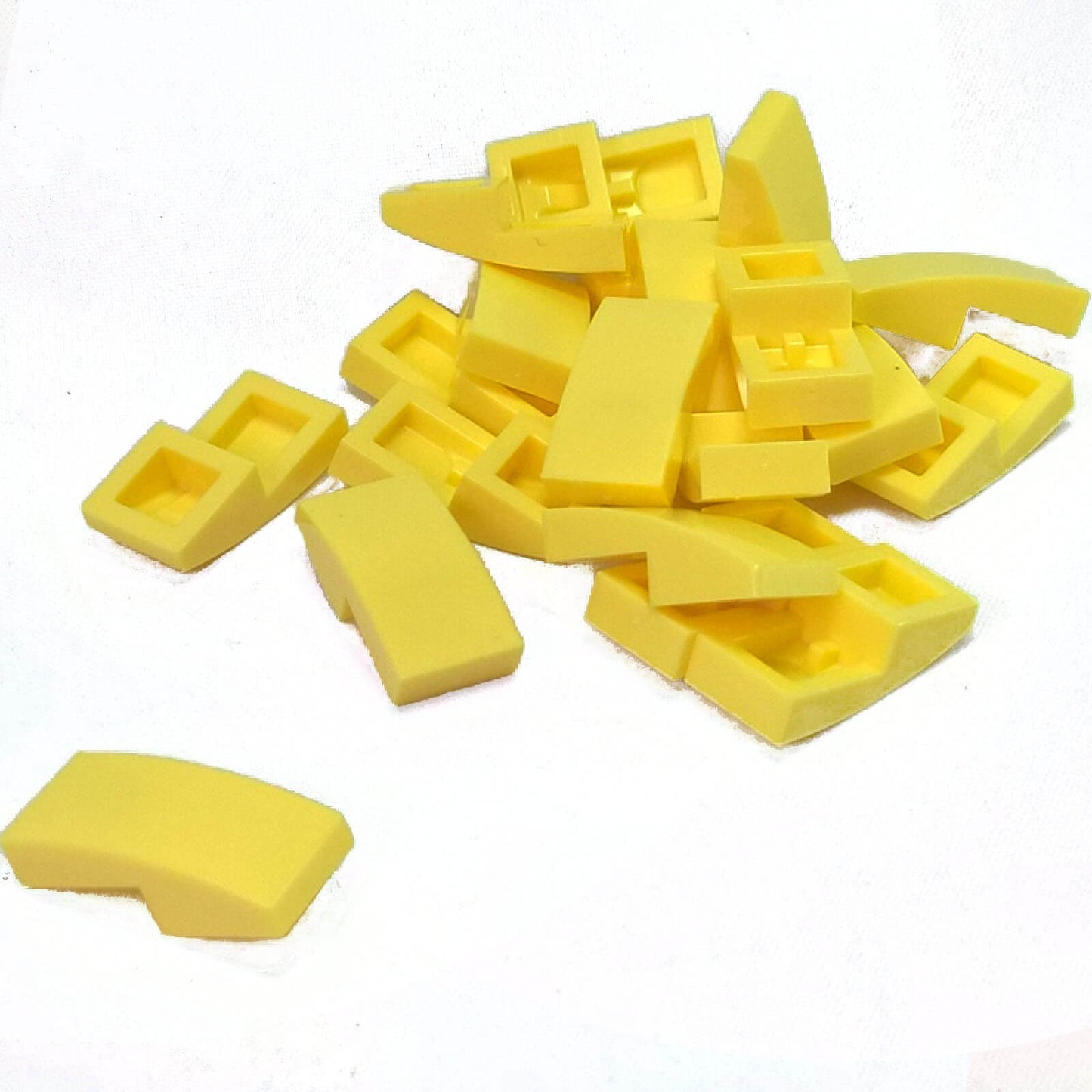 LEGO Curved Slope 2 x 1 x 2/3 part 11477 shown from top and underside bright light yellow