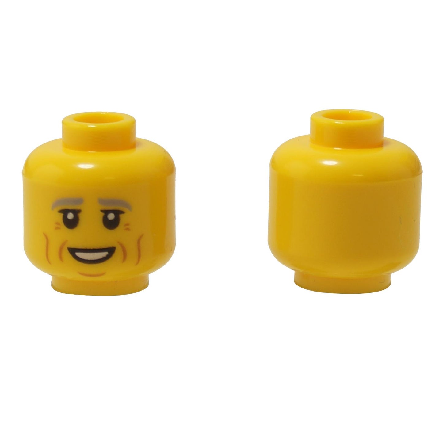 Front and alternate side views of the LEGO® minifigure head (3626pb2950) in classic yellow, featuring light gray eyebrows, gentle wrinkles, and a friendly smiling expression.