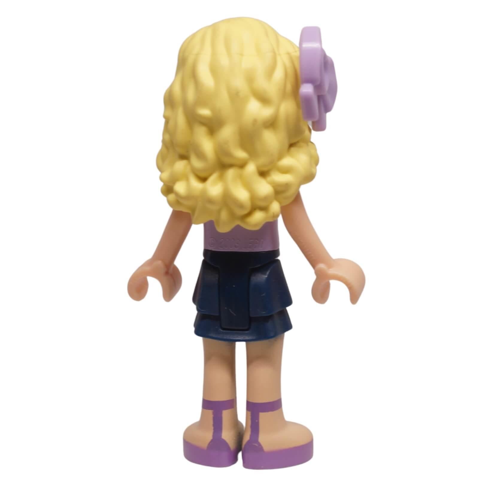 LEGO Friends Danielle mini-doll frnd0049 with lavender floral top, layered skirt, and bow hairpiece. From Downtown Bakery set, ideal for collections. Back profile