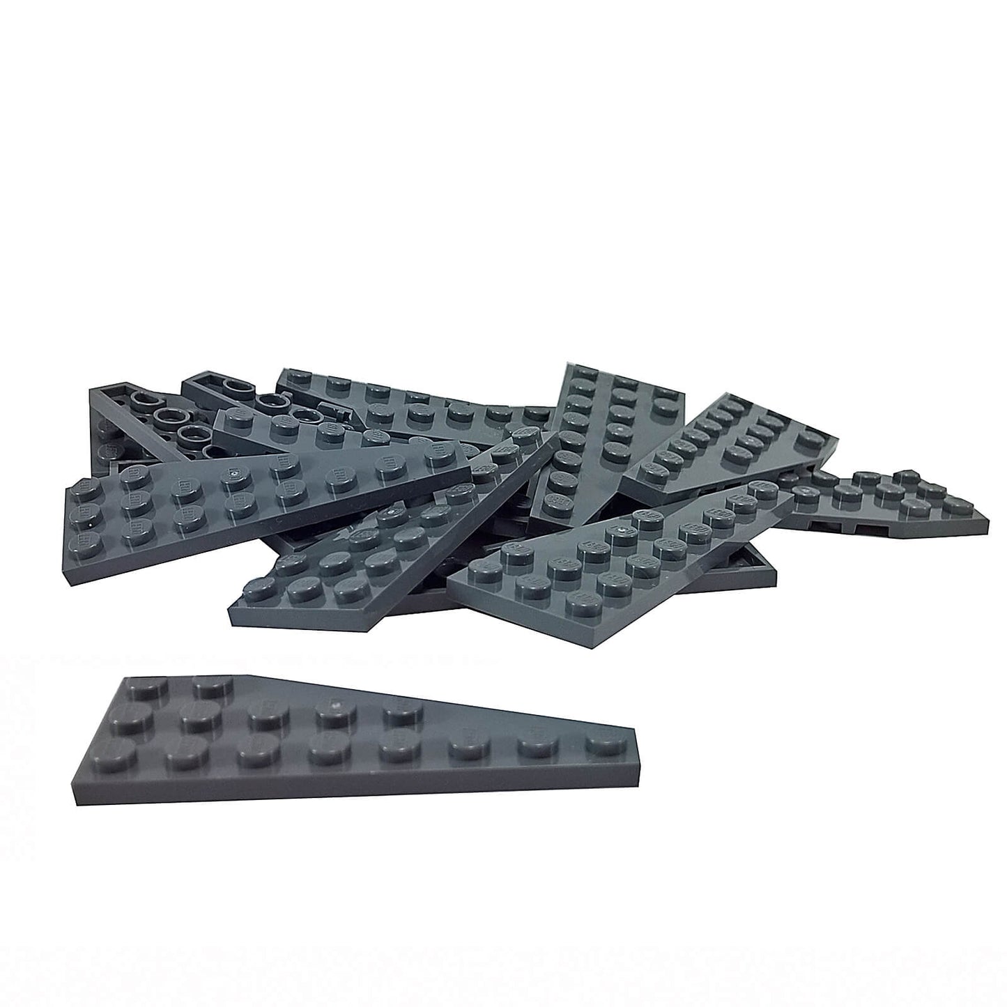Pile of dark bluish-gray LEGO Wedge Plate 8x3 Left pieces (50305) on a white surface.