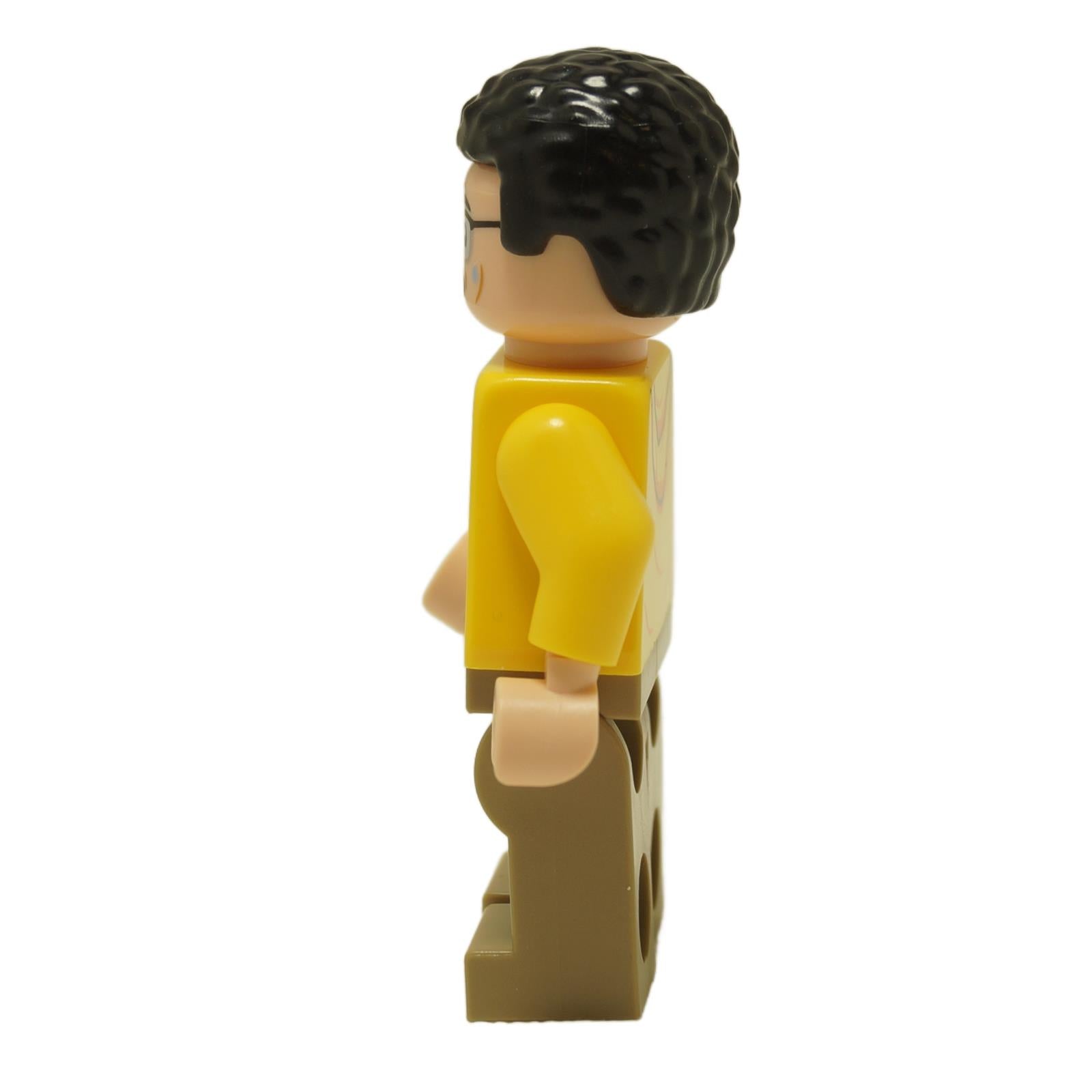 Side view of LEGO® Jurassic World Dennis Nedry minifigure jw106 wearing a yellow jacket over a dark blue undershirt
