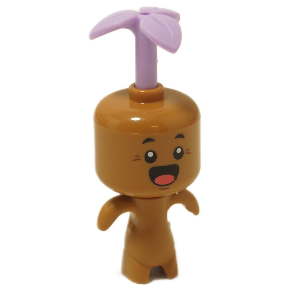 A LEGO minifigure named Dreamling with a medium nougat-colored body, a large expressive head with a joyful face, and a whimsical lavender leaf sprouting from the top.