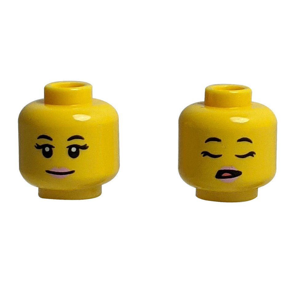 Dual-sided LEGO head 3626pb3439 with smiling and sleeping female faces.