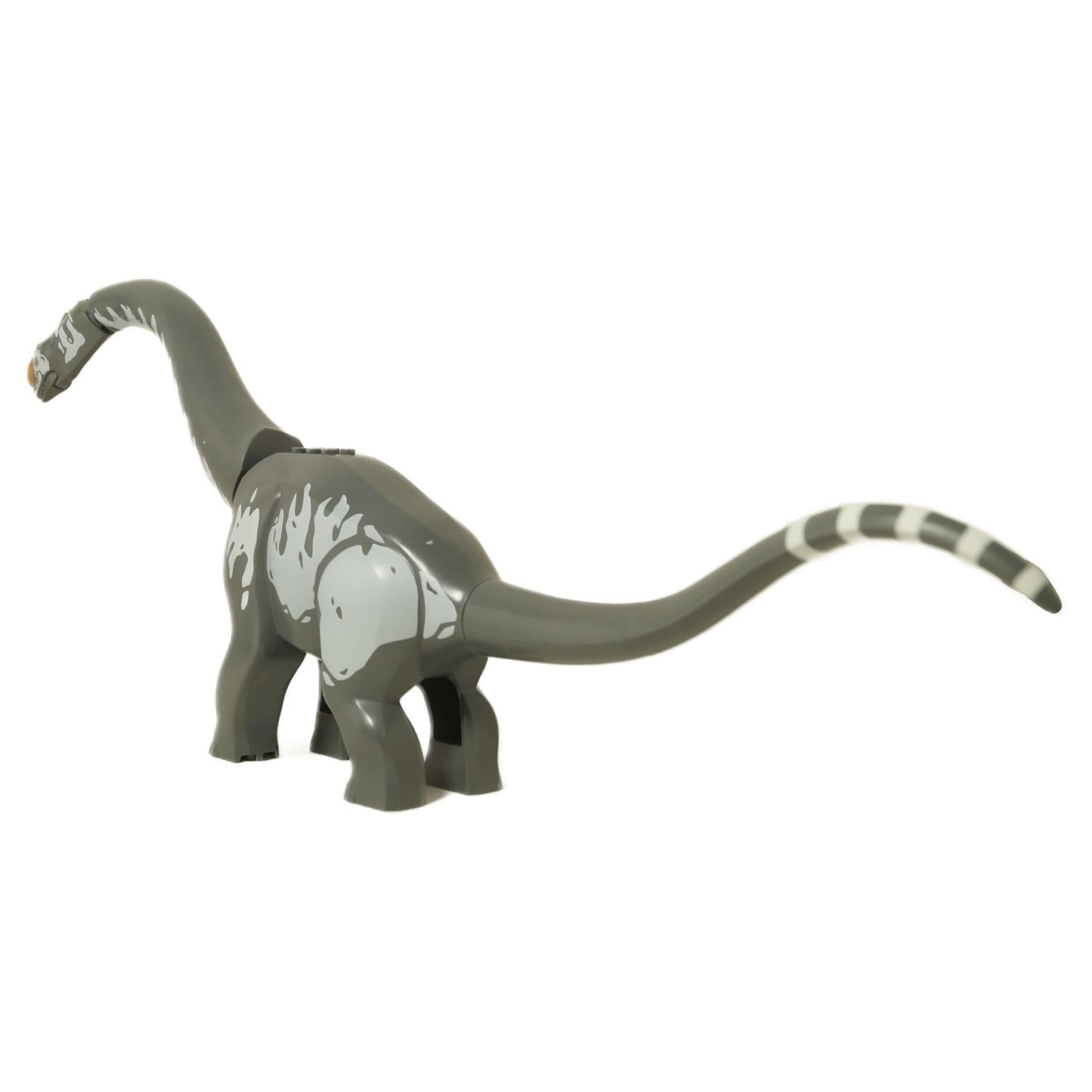 Angled side view of the LEGO Titanosaurus, highlighting the grey body stripes and striped tail tip.