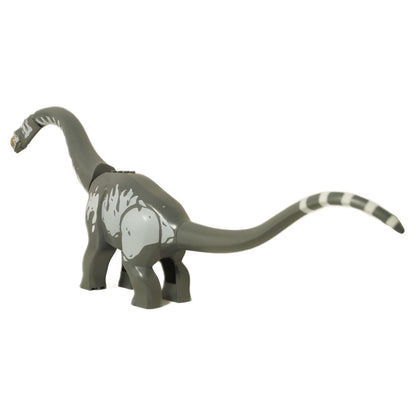Angled side view of the LEGO Titanosaurus, highlighting the grey body stripes and striped tail tip.