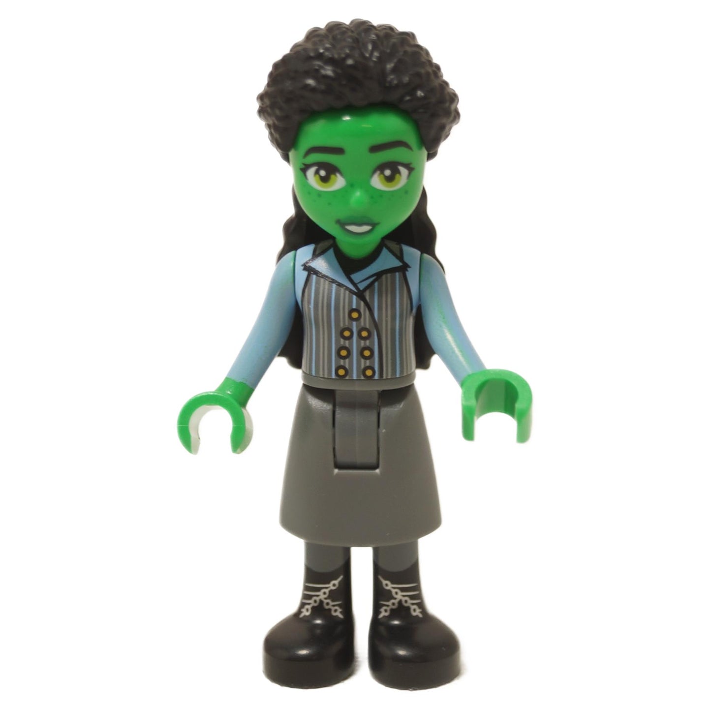 Elphaba minifigure with green skin, dark bluish gray skirt and black boots, wearing vest and light blue shirt
``
