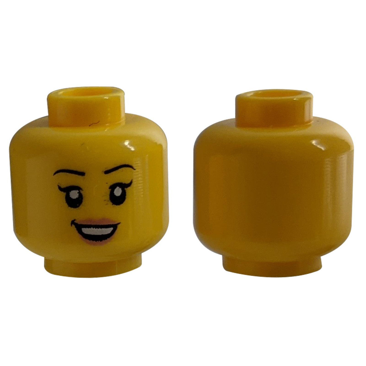 Yellow LEGO head 3626pb2381 with eyelashes and nougat lips, front and back.