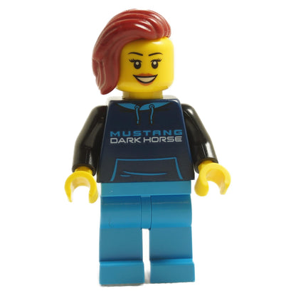 LEGO minifigure representing a Ford Mustang Dark Horse Driver with red hair, wearing a navy hoodie with the text 'MUSTANG DARK HORSE' on it, and blue pants.