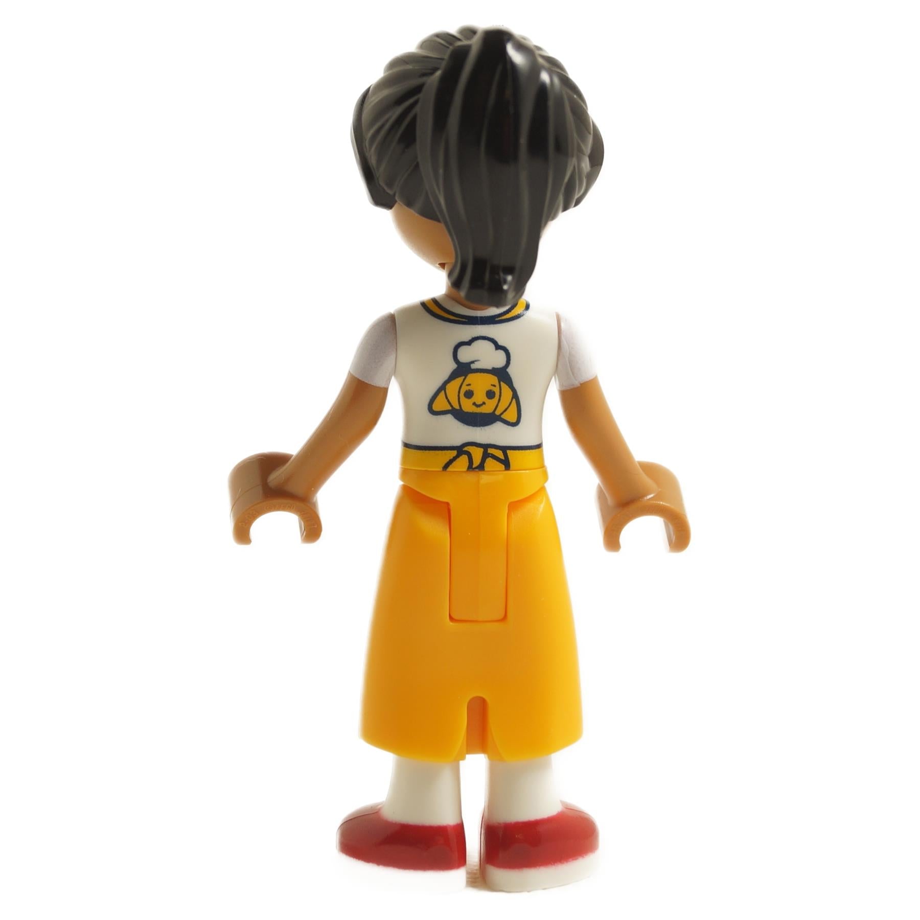 Back view of LEGO Friends Beatriz mini-doll frnd0747 with dark hair, white shirt with chef logo and yellow skirt
