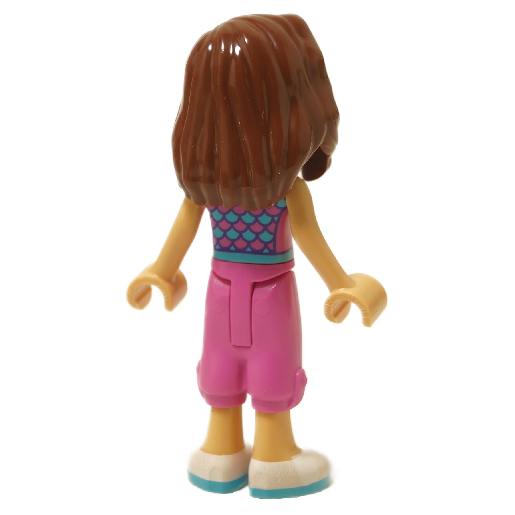 Back view mini doll with brown hair, teal scale top, pink shorts and white shoes

