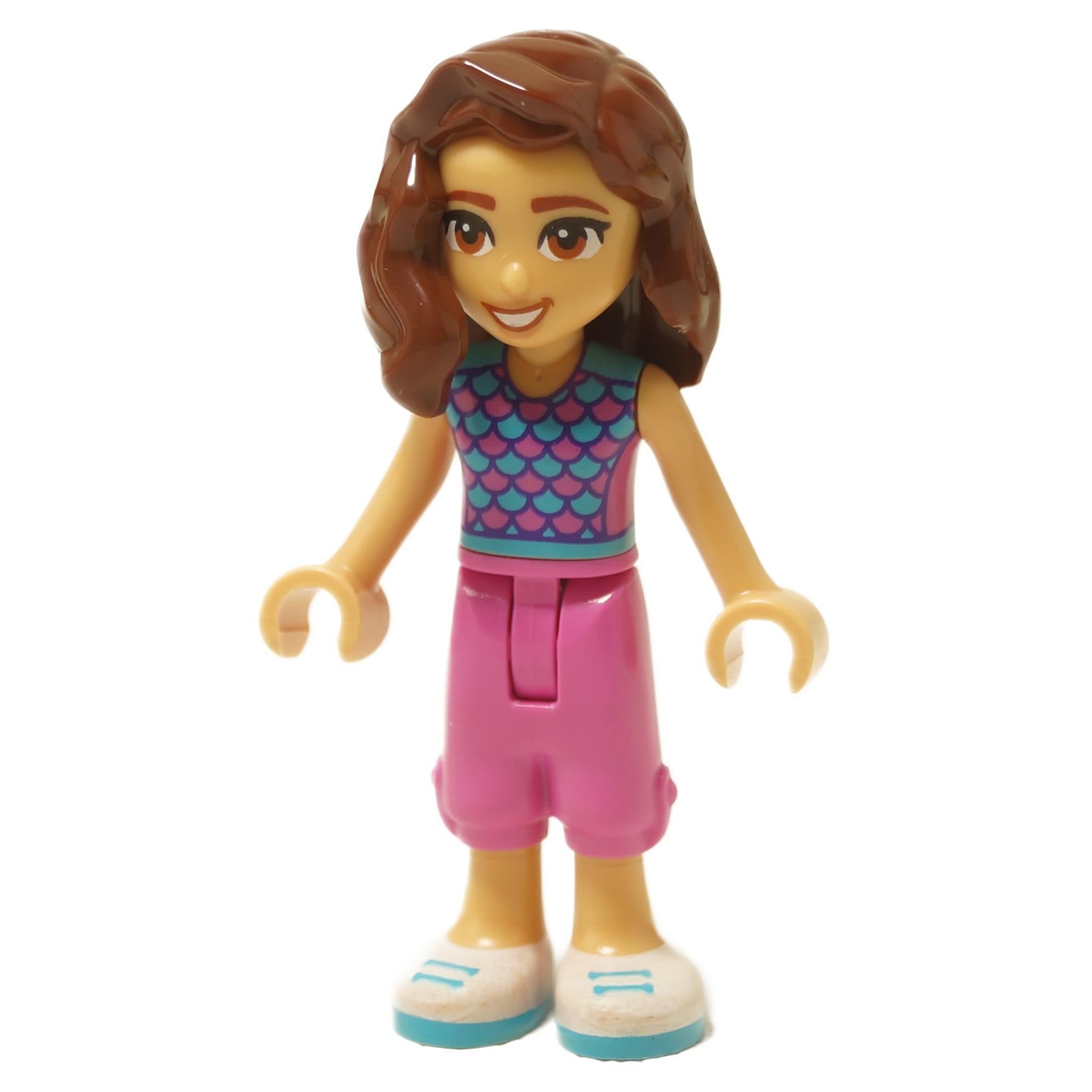 Mini doll figure with brown hair, teal scale top, pink shorts and smiling expression

