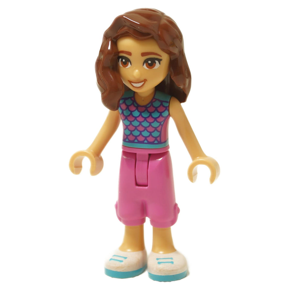 Mini doll figure with brown hair, teal scale top, pink shorts and smiling expression
