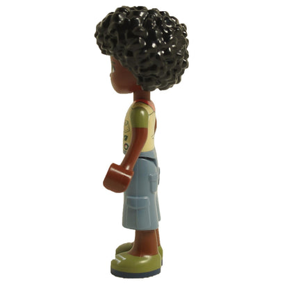 Side view of LEGO® Friends Joaquim mini-doll frnd526 wearing scout vest with badges, blue shorts and curly hair