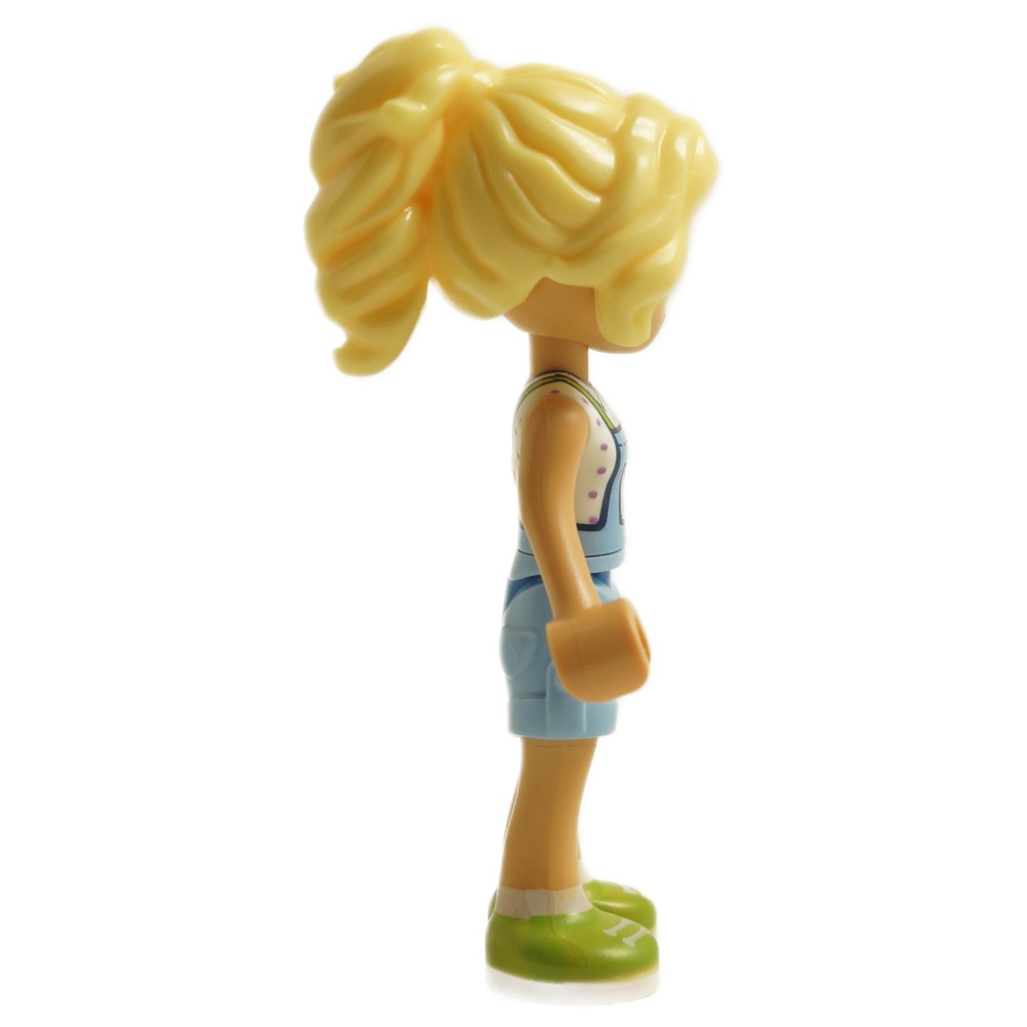 Side view of LEGO® Friends Kaya mini-doll frnd0685 with blonde hair, light blue overalls, and lime green shoes
