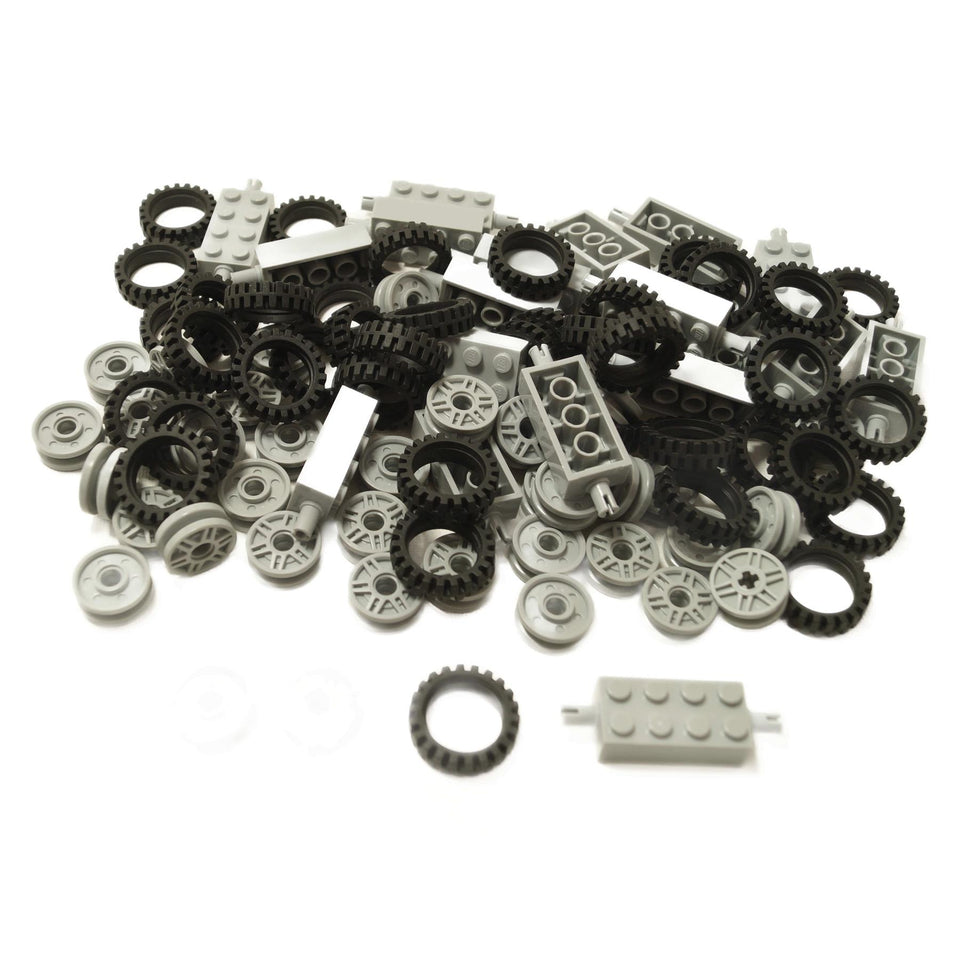 Bulk lot of 100 LEGO® parts including black tires, light bluish gray wheels, and Technic axle bricks for vehicle builds