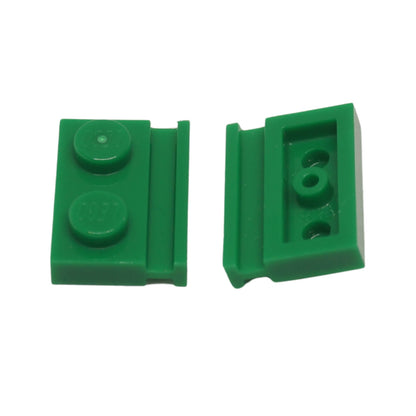 Green modified Plate 1 x 2 with door rail for sliding doors, track guides, and compact wall builds
