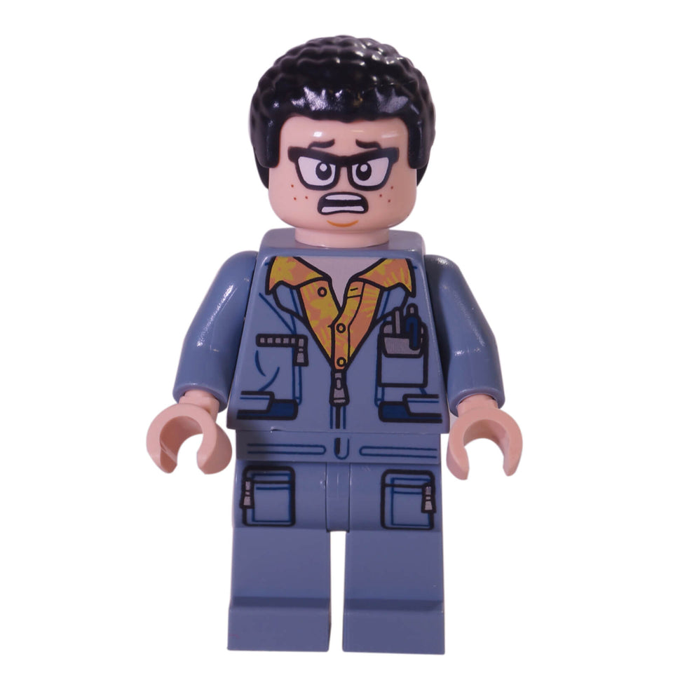 LEGO® minifigure of Leo from Jurassic World wearing a blue utility jumpsuit with printed tools, yellow shirt collar, and a concerned facial expression with glasses and freckles.
