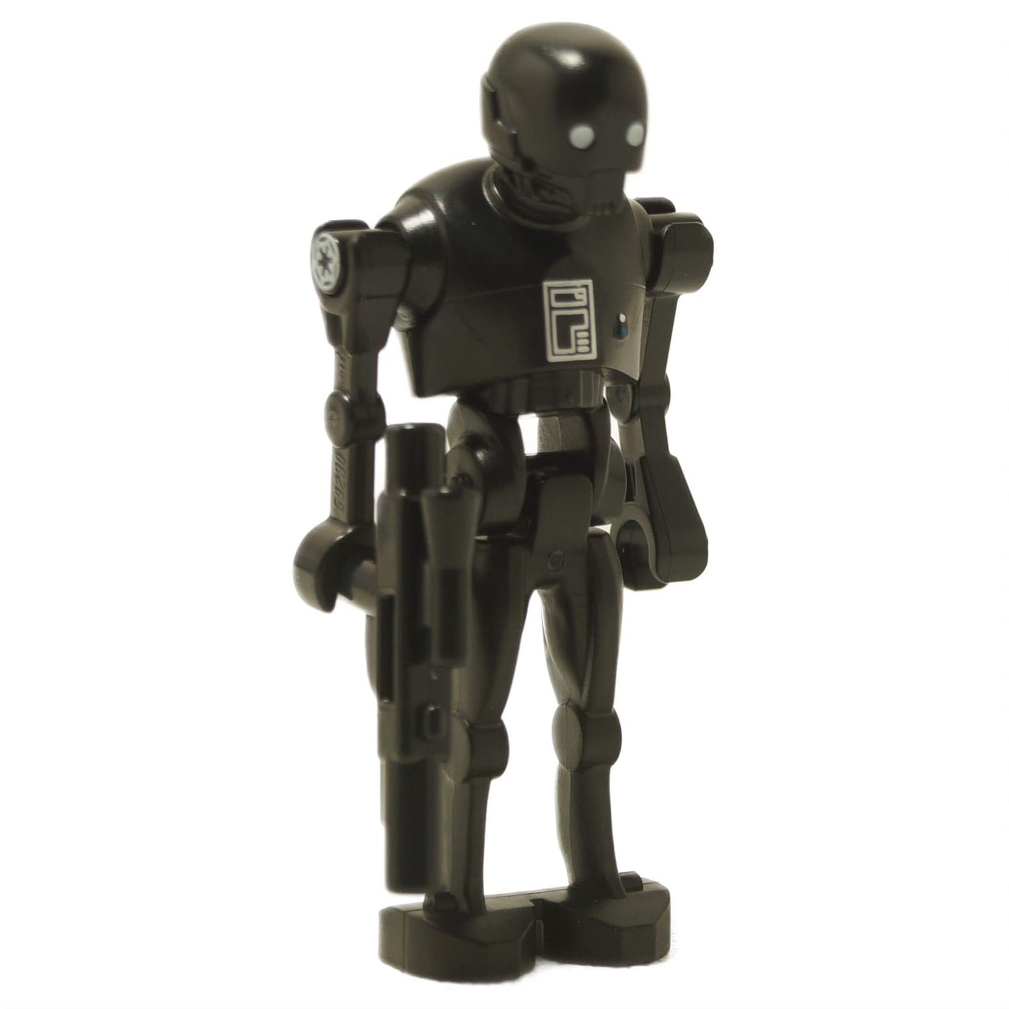 K-2SO droid minifigure front view holding blaster, black body with printed chest panel and long limbs
