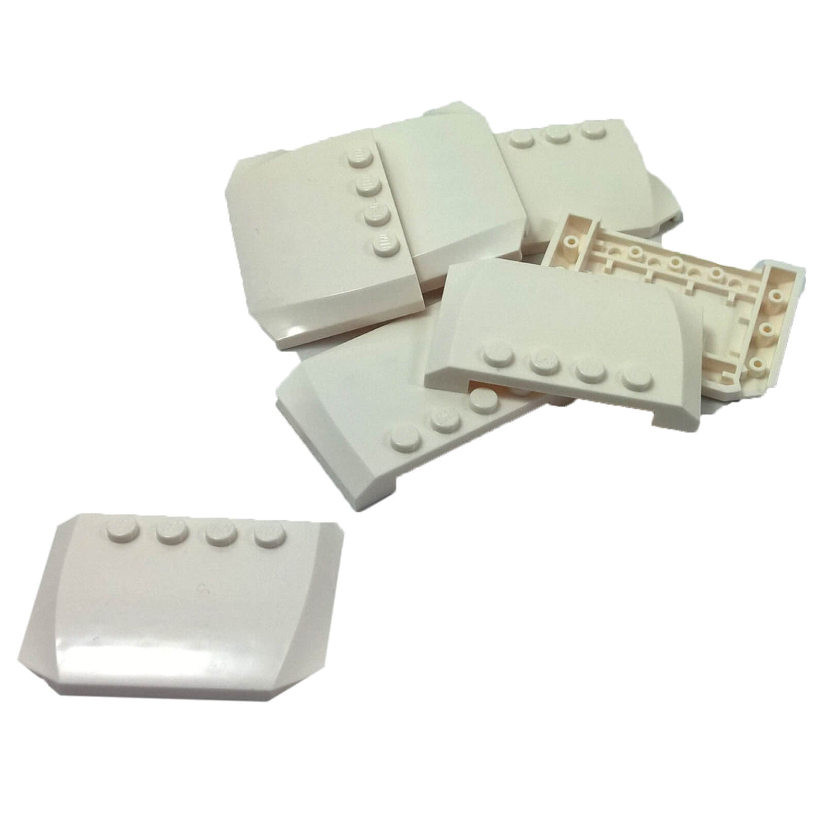 White LEGO® Part 52031 Wedge 4 x 6 x 2/3 Triple Curved with a smooth rounded surface, tapered profile and visible studs