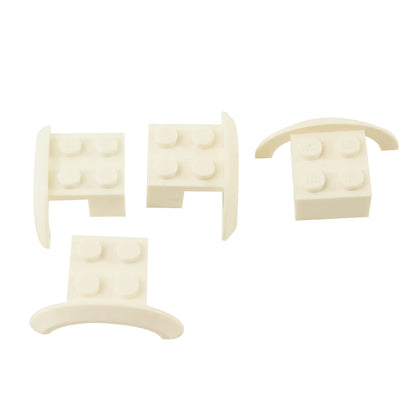 Four white LEGO® Part 98282 vehicle mudguards with rounded fender arches and four-stud mounting sections, shown from different angles