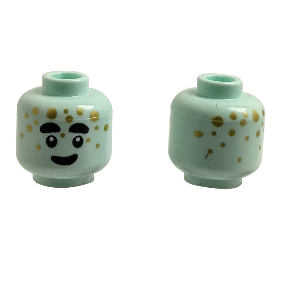 Front and back of light aqua LEGO head 3626pb3437 with alien face and gold dots.