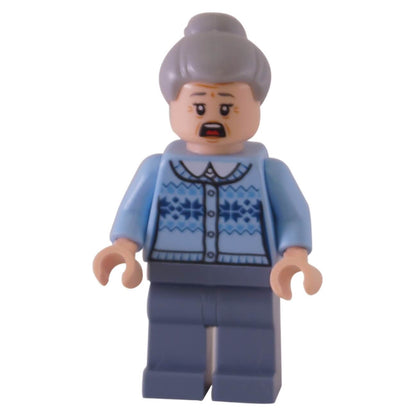 The LEGO Aunt May minifigure (sh544) with a scared expression, wearing a light blue fair isle sweater and with her gray hair in a bun.