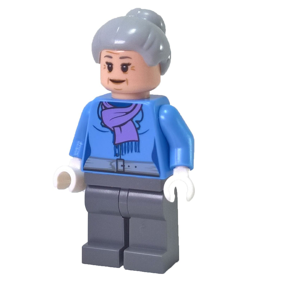 The LEGO Aunt May minifigure (sh272) in used condition, wearing a blue jacket with a lavender scarf and her gray hair in a bun.