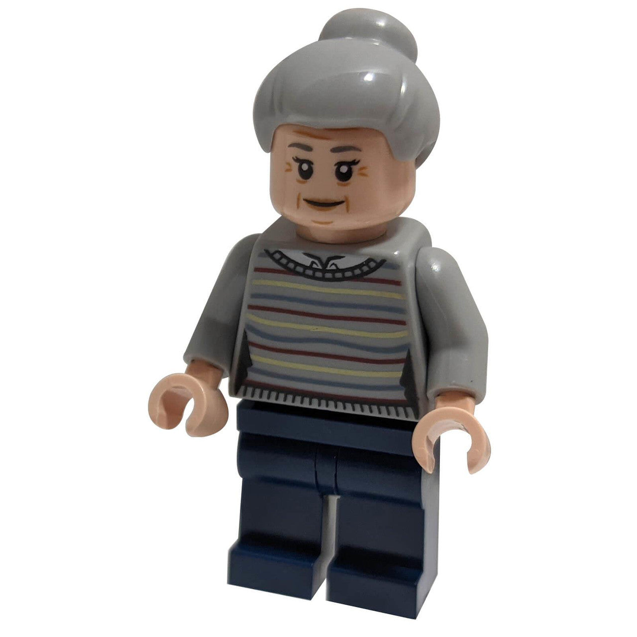 The LEGO Aunt May minifigure (sh721) smiling kindly, wearing a striped sweater and with her gray hair in a bun.