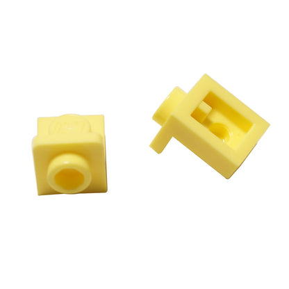 LEGO® Bracket 1 x 1 – 1 x 1 inverted in bright light yellow, compact connector for SNOT building techniques.
