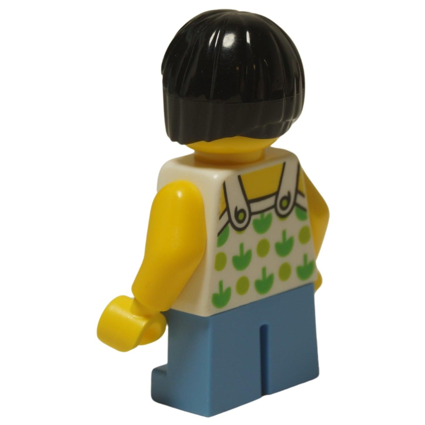 LEGO City child girl minifigure twn322 with green apple shirt and short legs. Back profile view.