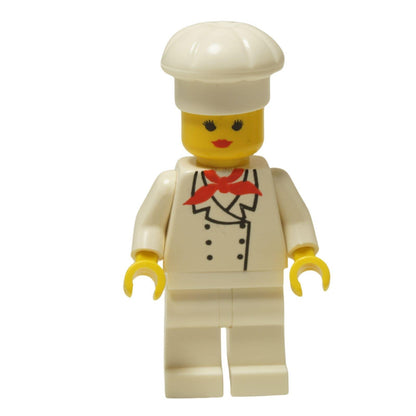 LEGO® Klasická minifigurka Female Chef (chef006) s ženským obličejem, oblečená do bílého uniformy a vysoké kuchařské čepice.