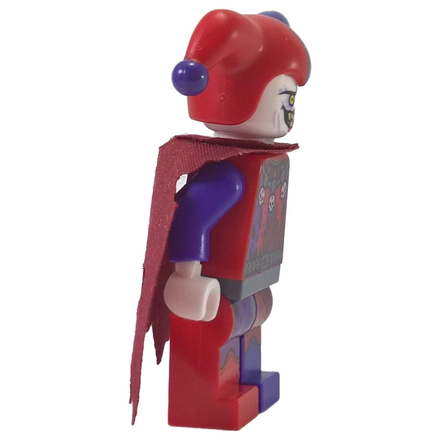 LEGO Nexo Knights Jestro minifigure nex013 with red and purple jester hat and tattered cape. Side profile.