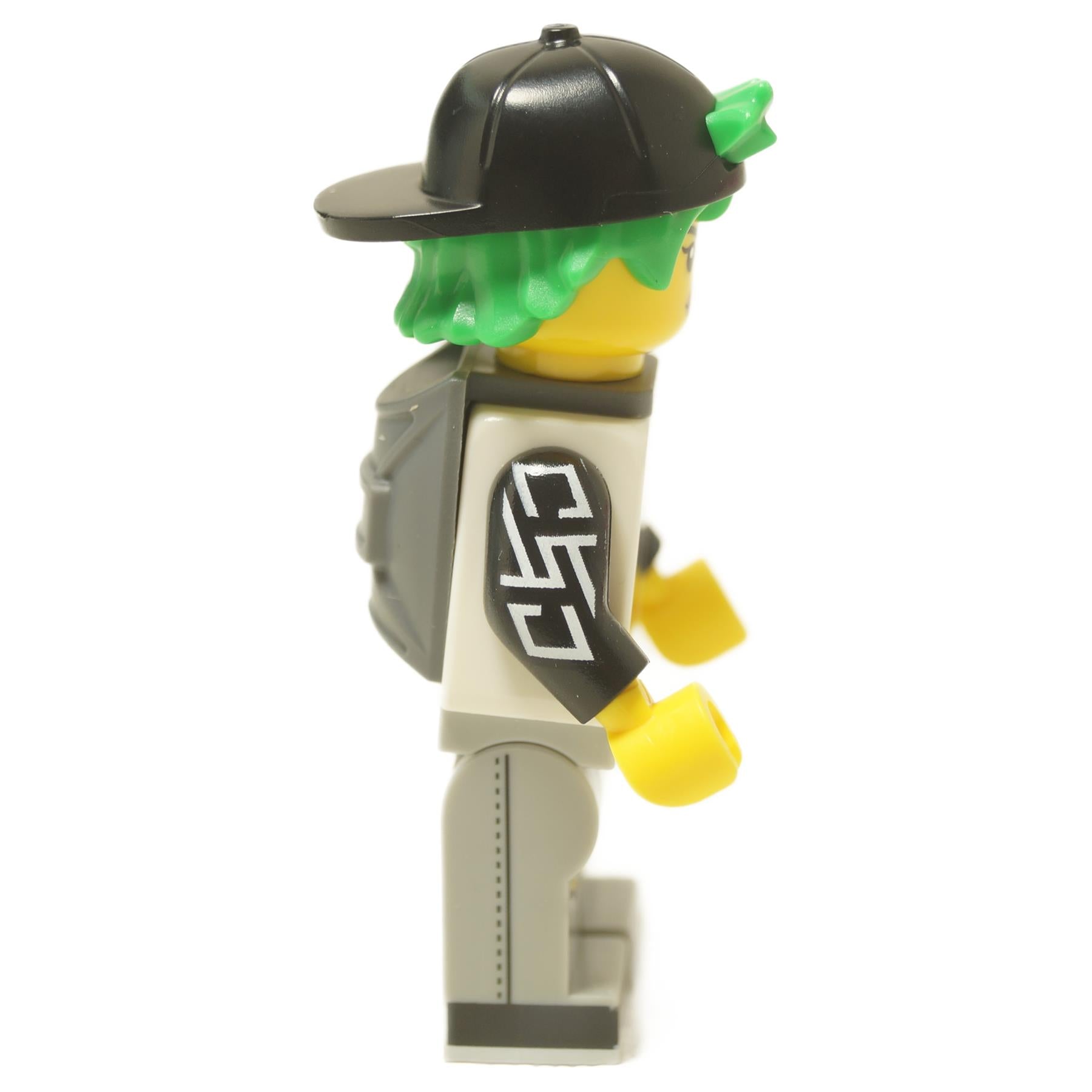  LEGO® Longboarder minifigure (col455) from Collectible Minifigures Series 27, with green hair, a backward cap, and ripped jeans. Side view.