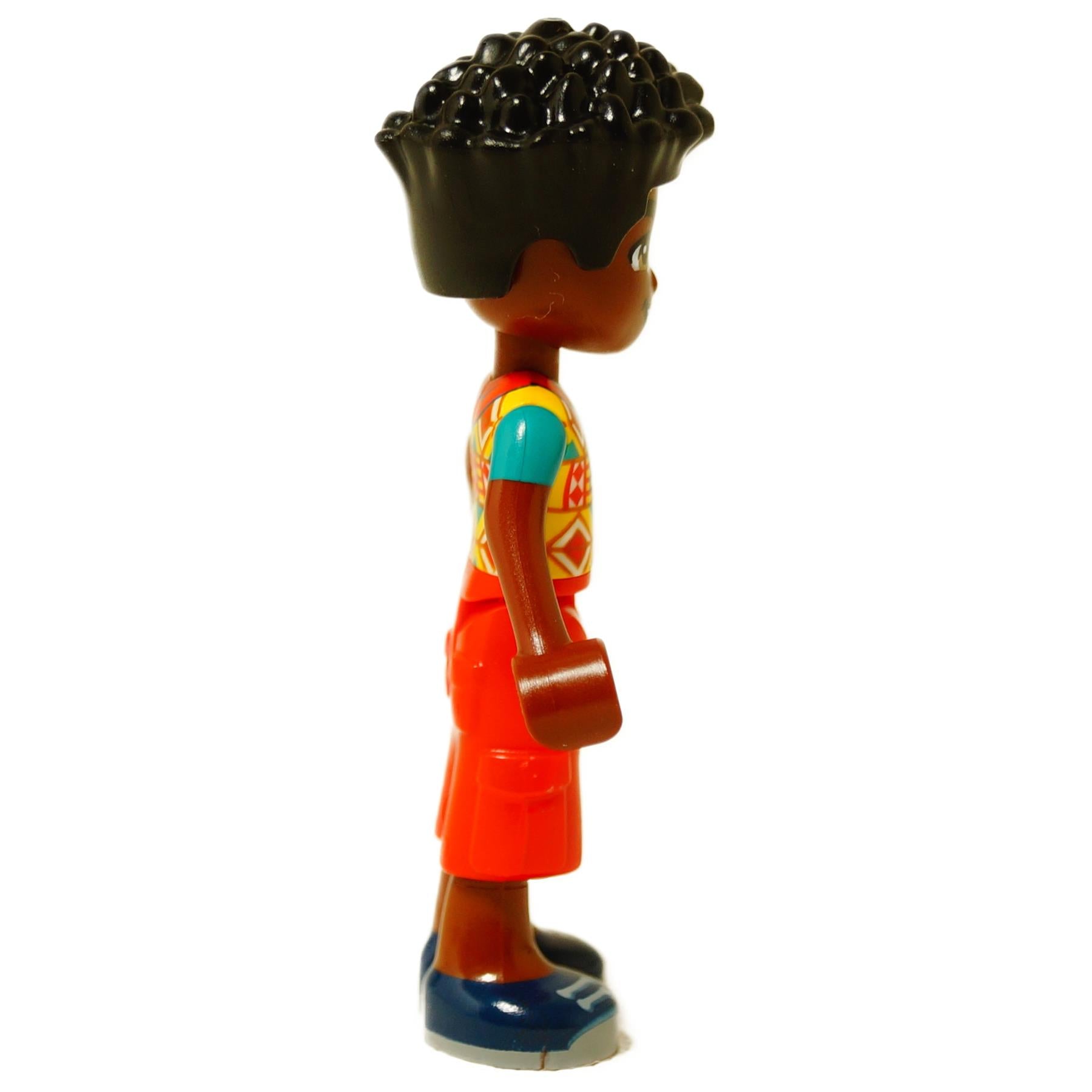 LEGO® mini-doll Zac wearing a geometric patterned shirt and red shorts, Friends-style figure with curly hair, side profile view
