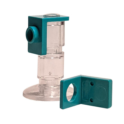 A LEGO minifigure neck bracket with a back stud, made of clear plastic with a green connector piece.