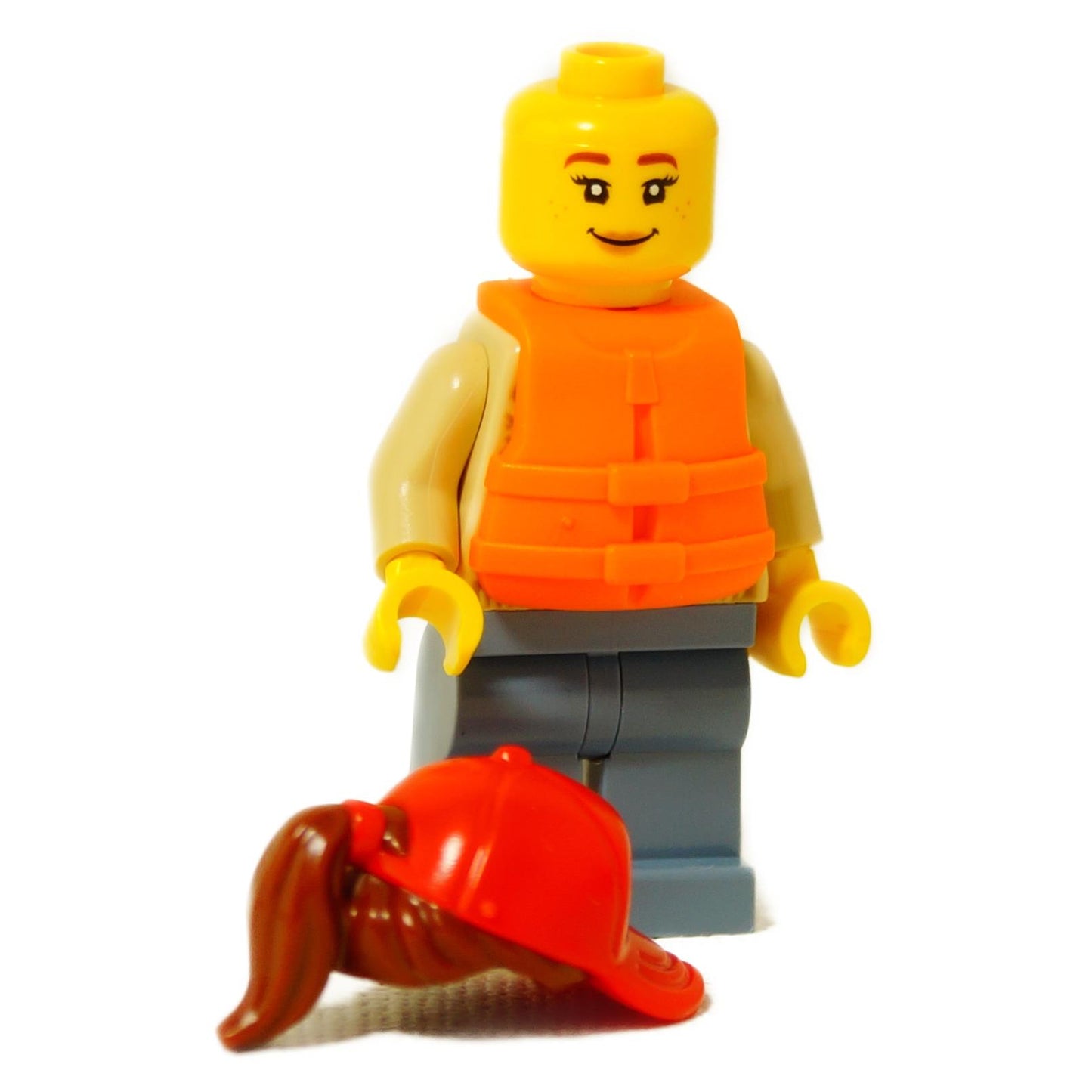 LEGO® woman minifigure with orange life jacket and sand blue legs, shown without red cap to display brown ponytail hair
