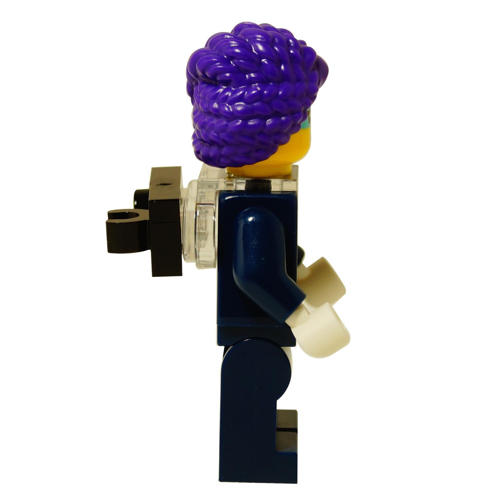 LEGO® DREAMZzz Zoey minifigure with purple hair and clip, dark outfit with colorful graphic patterns back profile view