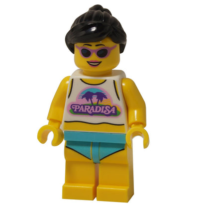 The LEGO Paradisa Beach Bae minifigure (idea231) smiling while wearing a Paradisa logo tank top, teal shorts, and cool purple sunglasses.