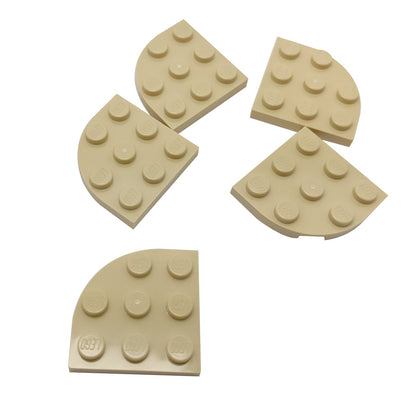 Tan LEGO® round corner plate 3×3, a curved 90-degree connector piece used for shaping bases and smooth structural edges.
