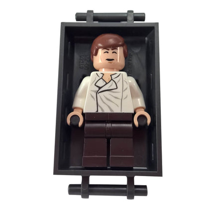 LEGO® Star Wars Han Solo sw0714 with White shirt and Dark Brown legs alongside Pearl Dark Gray Han Solo inside carbonite block