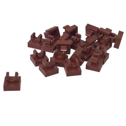 LEGO® Tile Modified 1 x 1 with open O clip (15712) in reddish brown, a small connector tile with a circular side clip.
