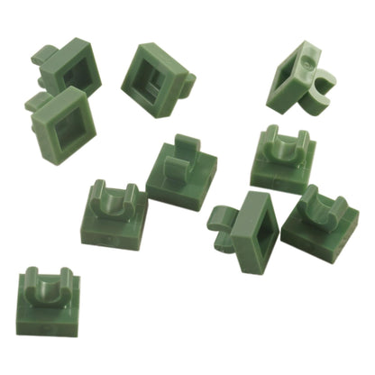 LEGO® Tile Modified 1 x 1 with open O clip (15712) in sand green, a small connector tile with a circular side clip.
