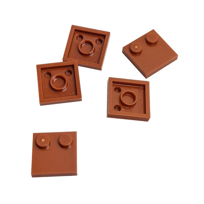 LEGO® Tile, Modified 2 x 2 with Studs on Edge (Part 33909) in dark orange, used for SNOT techniques and detailed surface building
