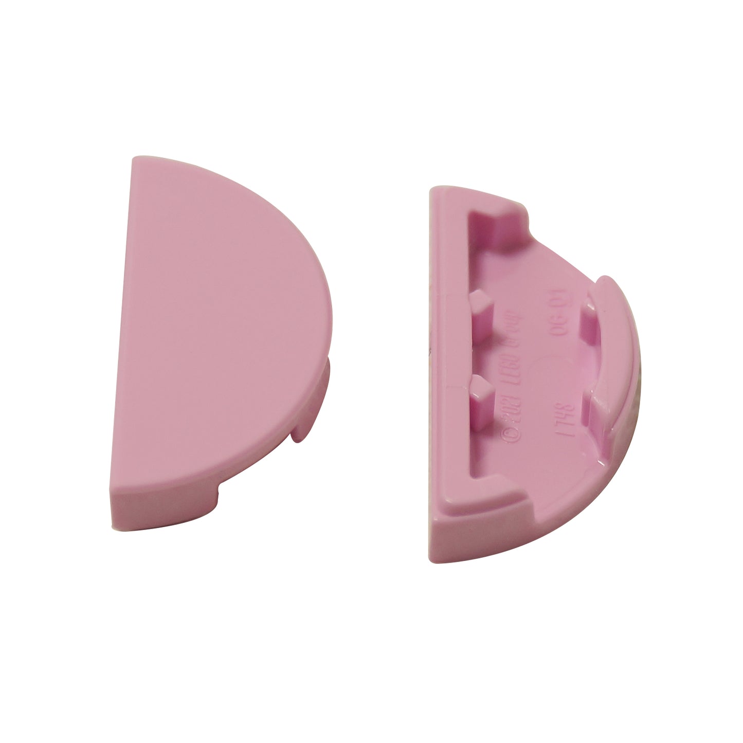 LEGO® Tile Round 1 x 2 Half piece shown in close-up, featuring its smooth curved top and half-moon shape in bright pink.