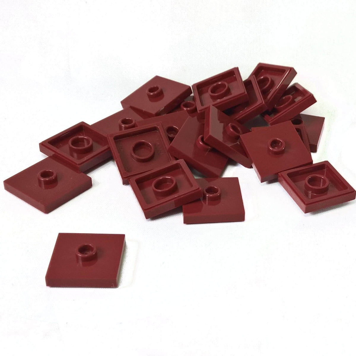 LEGO Plate Modified 2 x 2 with Groove and 1 Stud in Center part 87580 shown from top and underside, dark red