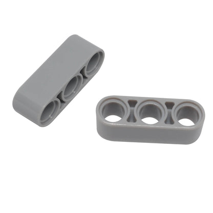 light bluish gray LEGO Technic 1x3 Thick Liftarm pieces (32523) loosely grouped.