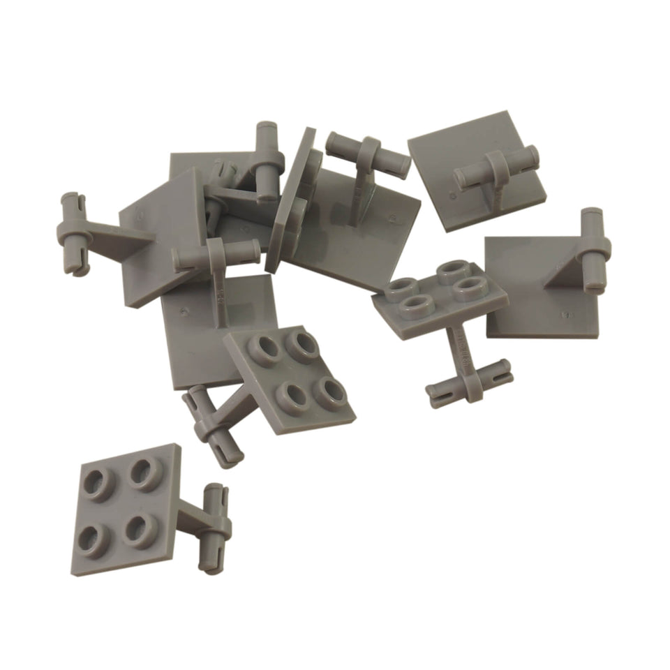 Pile of light bluish-gray LEGO Plate 2x2 with Dual Wheels Holder (4870) showing studs and axle connectors.