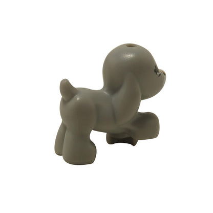 Light bluish gray walking puppy figure with raised front paw and curled tail.
