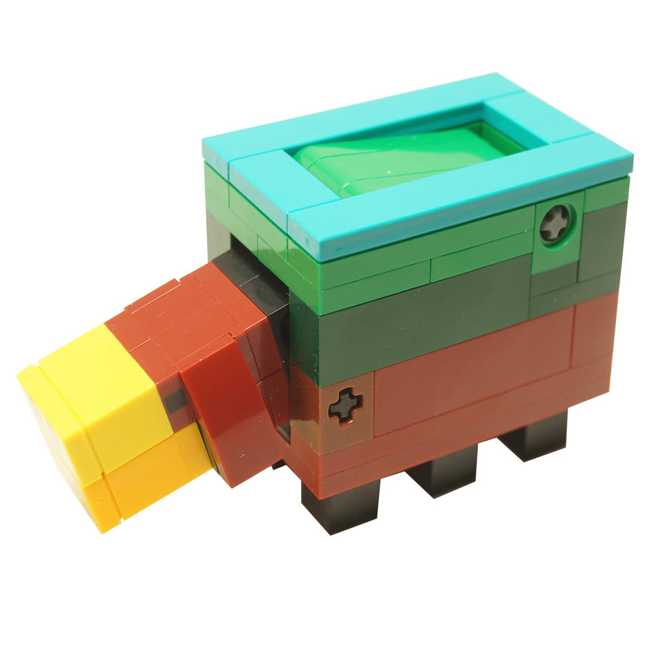 LEGO Minecraft Baby Sniffer brick-built figure featuring a blocky multicolor design with teal frame, green top, orange snout, and small black legs